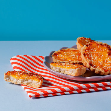 Caramelised Peach and Coconut Tarts on a plate - from our range of cakes and tarts for coffee shops